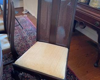 One of the arm less mahogany dining chairs.