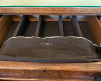 The inside of one of the drawers of the silverware chest