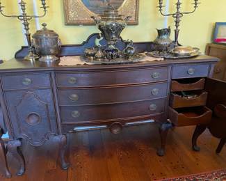 A closer look at the details on the mahogany buffet and the silver ware storage drawers inside the cupboards
