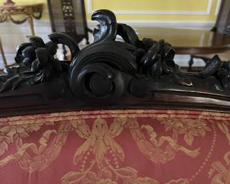 Wood carved detail at the top of the sofa