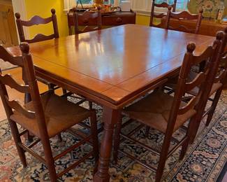 This table is in the dining kitchen. Solid maple table 42" x 60" with sliding extensions at each end. There are 8 solid maple ladder back chairs