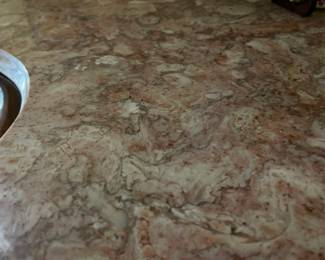 Pink marble top of the mahogany console