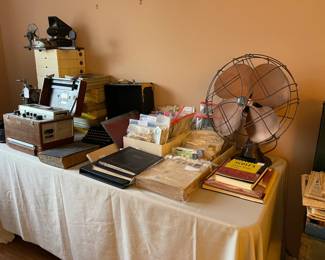 This table is in the bedroom with the Mid-Century Modern furniture. Lots of stamps, stamp collection books, stamp books, first day covers