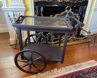 Mahogany tea cart with removable glass tray and one shelf. 18" x 24" x 27"