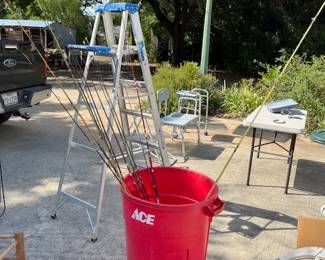 Fishing poles in the red trash can