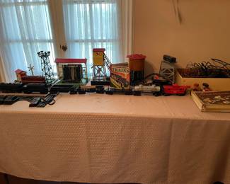 Lionel train set with buildings, track, cars, etc. All of the train pieces will be sold as a set. This is located upstairs. You might want to bring some boxes...