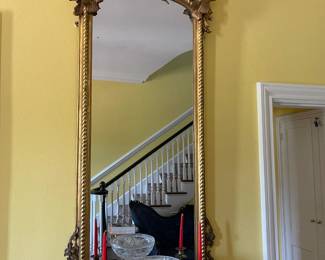 A close look at the Chippendale mirror, pair of brass candle sticks and brass base cut glass compote