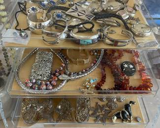 This showcase contains, Italian beads, amber, sterling Christmas ornaments, vintage costume, Handmade sterling and Navajo pieces and watches