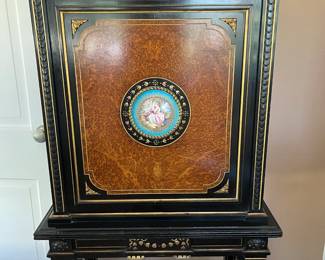 There are two of these beautiful blackwood Victorian cabinets, velvet lined with brass trim and gallery at top, Ambogna paneled doors and French Sevres insets. 25" wide, 59" tall and 13" deep. Circa 1880