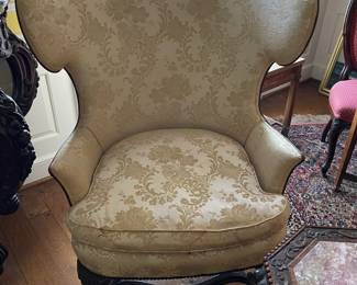 Antique and original to the house, wing back parlor chair with silk brocade upholstery