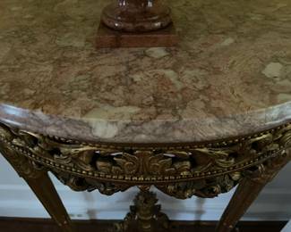 Pink marble top of the gold leaf console table