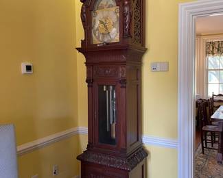 Antique Mahogany Grandfather Clock made by the Walter H. Durfee Co in Providence Rhode Island. It is heavily carved with angels on each side of face. It has patent dates on the tubular chimes of 1887 and 1888.