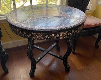This incredible table can be found on the upper landing. Japanese with two colors of marble and mother of pearl inlay. This piece is original to the house.