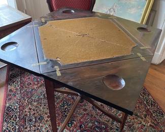 The inside of the envelope game table with original felt.
