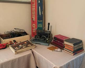 Box on left contains Lionel train track and cables, old toys and old books