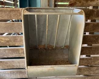 This horse trough just hooks over the top of the wall.