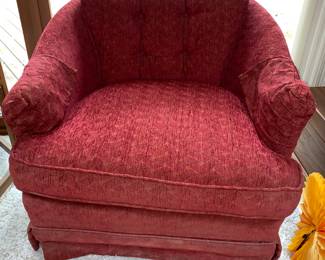 1 of a pair of red swivel chairs