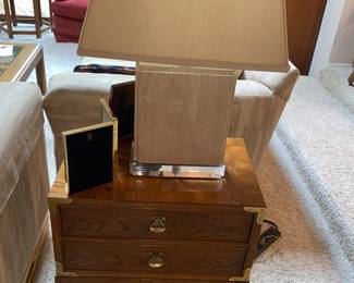 Wood end table with brass accents and 80s lamp