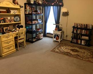 Cute yellow bedroom furniture.  Some wicker, games and books.