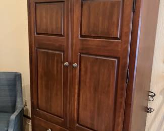 Big armoire or entertainment center.