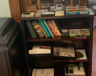 Book shelf with many decks of cards, bridge and duplicate items, books on bridge