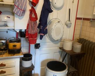 Several crocks, granite ware, vintage aprons, 2 plant stands
