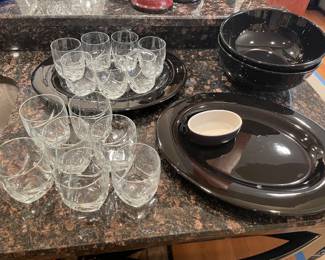 Black ceramic platters and bowls, and low -ball glasses