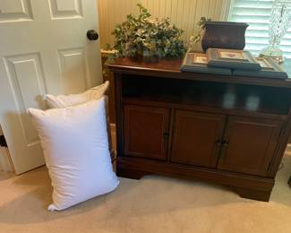 Another view of the media console cabinet by Thomasville, framed prints, like-new bed pillows and faux planter