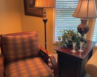 Another view of the curved accent armchair by Ethan Allen, floor and table lamps, and side table by Thomasville