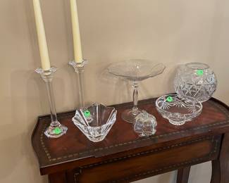 wood side table shown with Waterford and Fostoria glassware