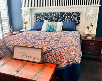 The bed in this photograph is not for sale, it is attached to the house. The large hand made quilt and the rest of the decor will be available
