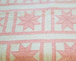 Pink and white Grandmother's quilt.