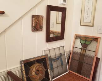 Foyer with numerous pieces of stained glass. 
