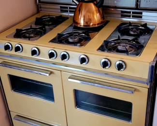 6 burner and 2 oven harvest gold stove. Circa 1970