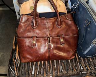Lots of handbags and purses.  Dooney & Bourke, Brighton, Coach are among the featured.