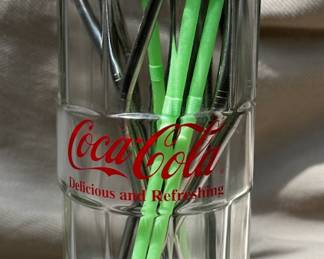 Coca-Cola straw dispenser.