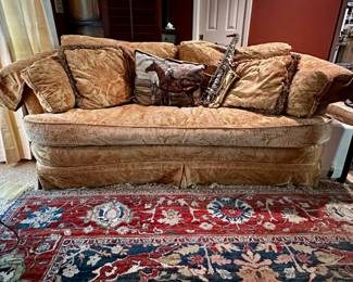 Selmer AS300 alto sax rests on gold upholstered sofa.