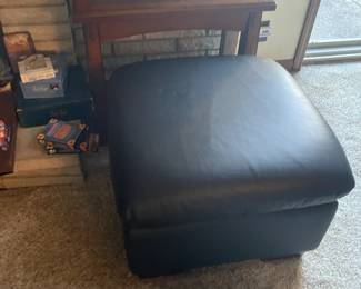 . . . black leather ottoman