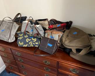 Lots of purses and hand bags 
