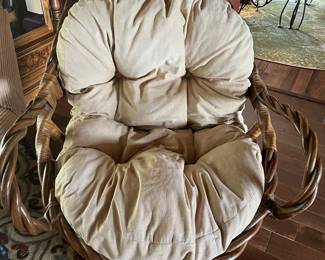 Rattan chair with swivel base and cushion