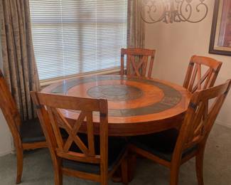 Very nice family dining table. Large round with stone like accents. 5 matching chairs.