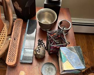 Assorted incense burners on a small, drop leaf maple table