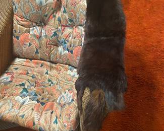 older wicker chair with old animal fur