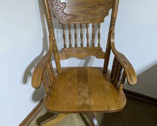 Antique wooden carved desk chair on wheels