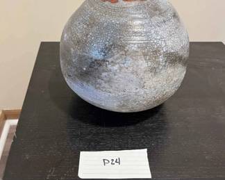 Ceramic Round Vessel With Small Hole Surrounded In Orange Design 