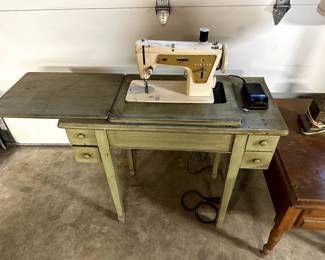 Antique sewing machine - not tested but worked last time used (25 years ago).  Includes cabinet.