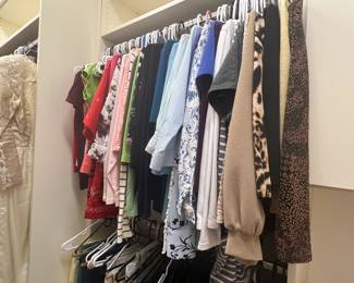 Full walk-in closet of women's clothing, shoes and bags