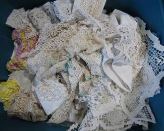 Large tub of antique laces and trims.