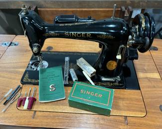 1948 Singer Class 66 sewing machine with accessories and booklet. Wonderful solid walnut cabinet with storage stool.