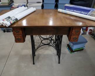Antique sewing machine cabinet converted into a tall cutting table.